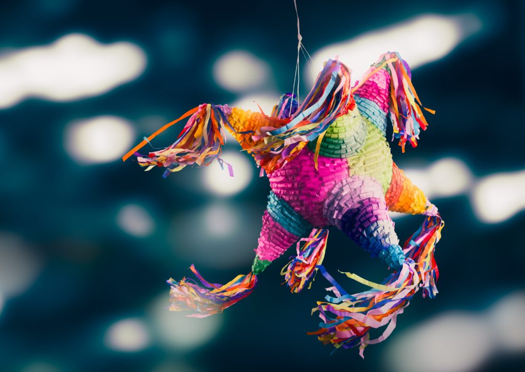 In Mexico, the piñata is an especially important part of Christmas for children. It’s a clay pot decorated with stars and figures and filled with fruit and candy. The piñata is hung up, and the blindfolded children try smashing it with sticks to get the treats.