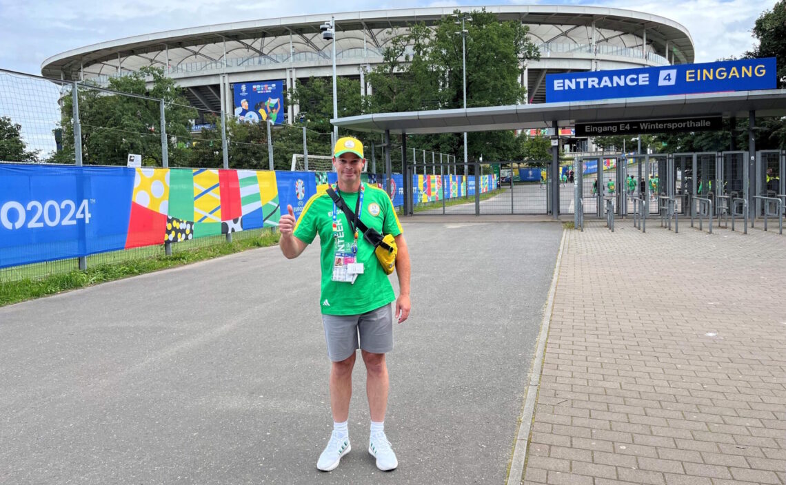 Image of Bruno Jacksteit as a volunteer in front of a football stadium