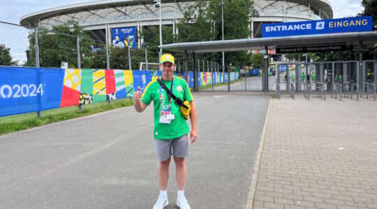 Image of Bruno Jacksteit as a volunteer in front of a football stadium