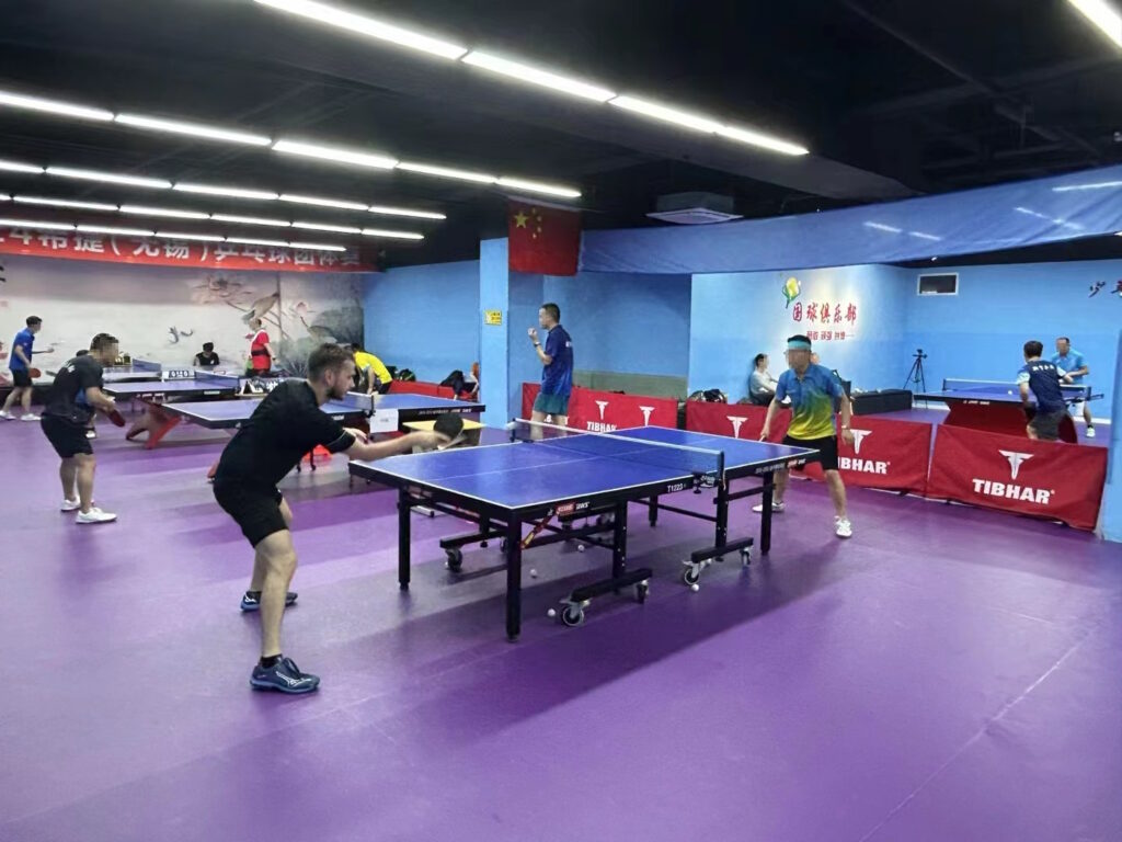 Image of David Schneider playing table tennis in China