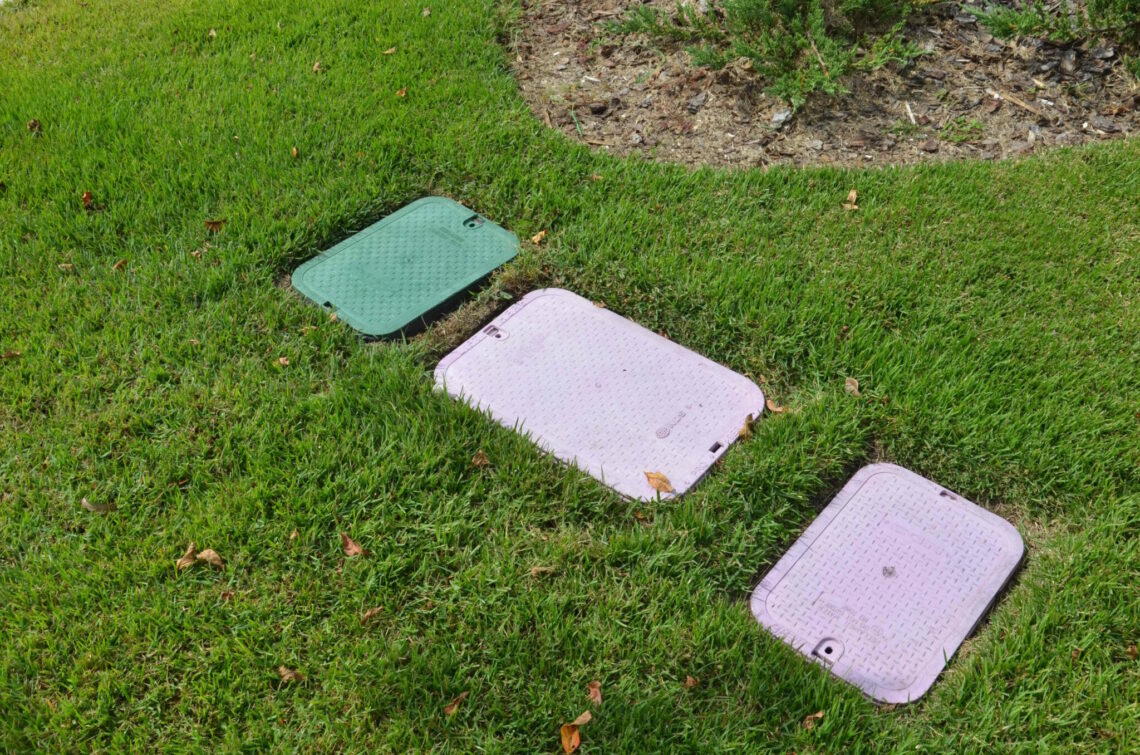 Front yard with NDS valve boxes in green and purple colors