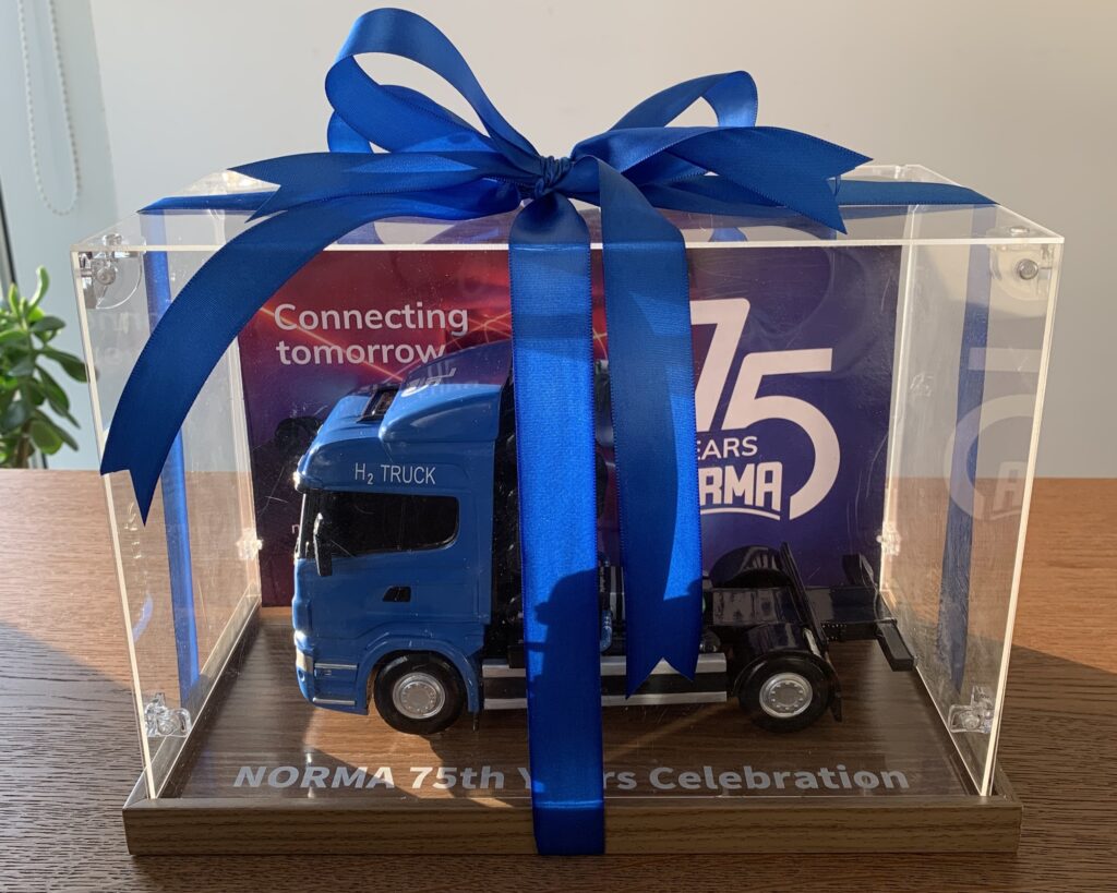 Image of model of NORMA Group's miniature truck as a gift