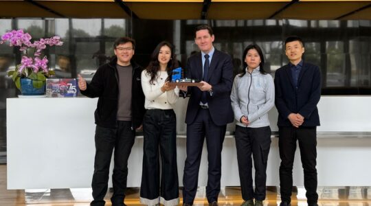 Image of NORMA Group team in Shanghai with model truck